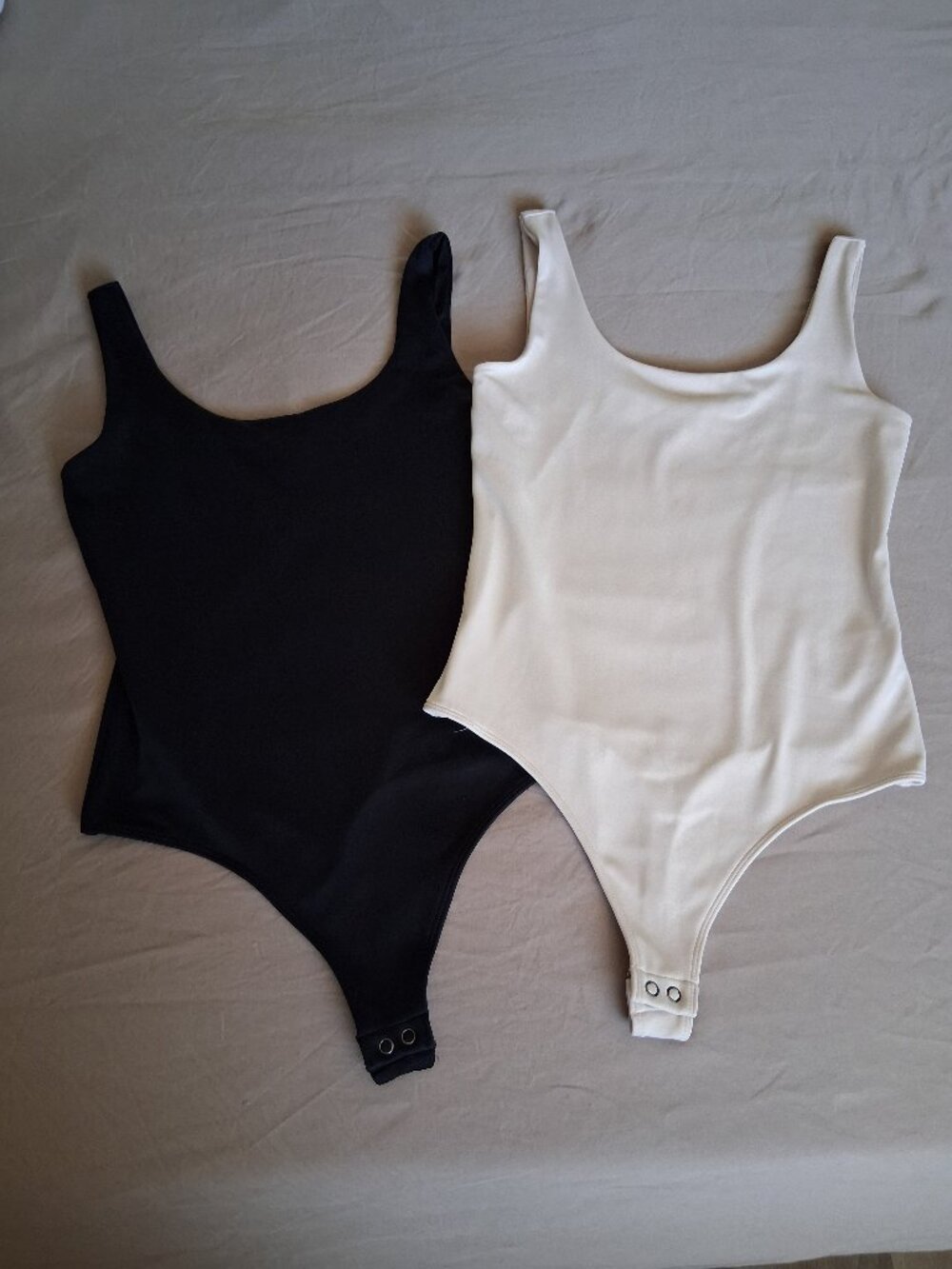 Two express body couture scoop Bodysuit. Body couture. It has a thong cut Size.S